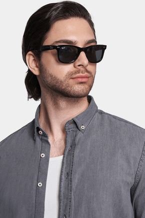 Gray denim shirt close-up with button collar and chest pocket detail