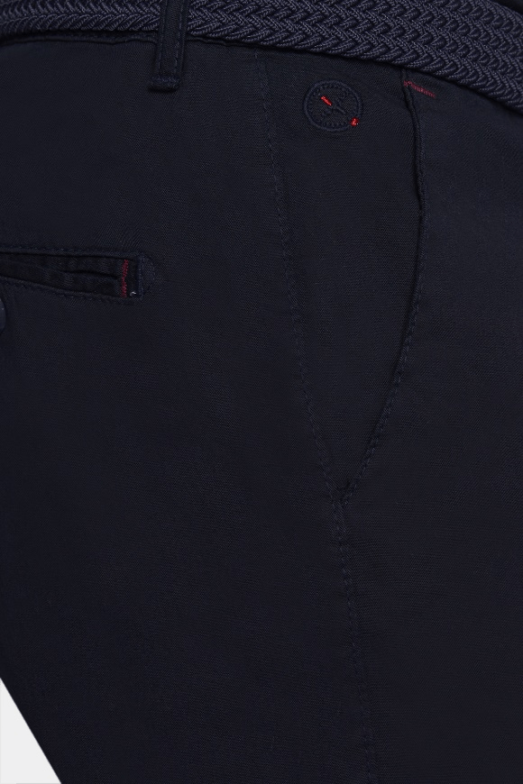 Navy shorts fabric close-up with stitched pocket and button detail