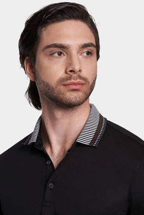 Men's black cotton polo shirt close-up with striped collar and partial button placket