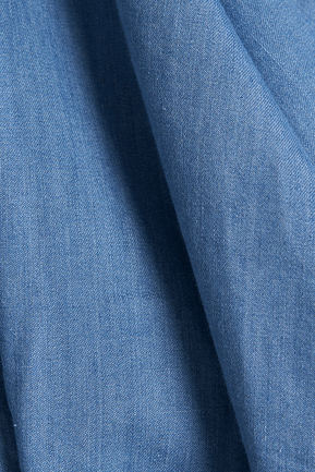Blue denim fabric close-up showing fine textured weave
