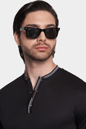 Black polo collar with quarter-zip and striped trim, worn by model.