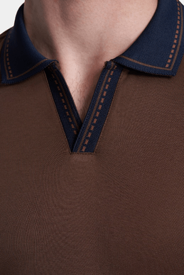 Close-up: chocolate open polo neckline with navy V-placket and stitched trim
