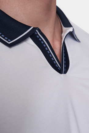Close-up of white polo placket with navy open collar and contrast stitching
