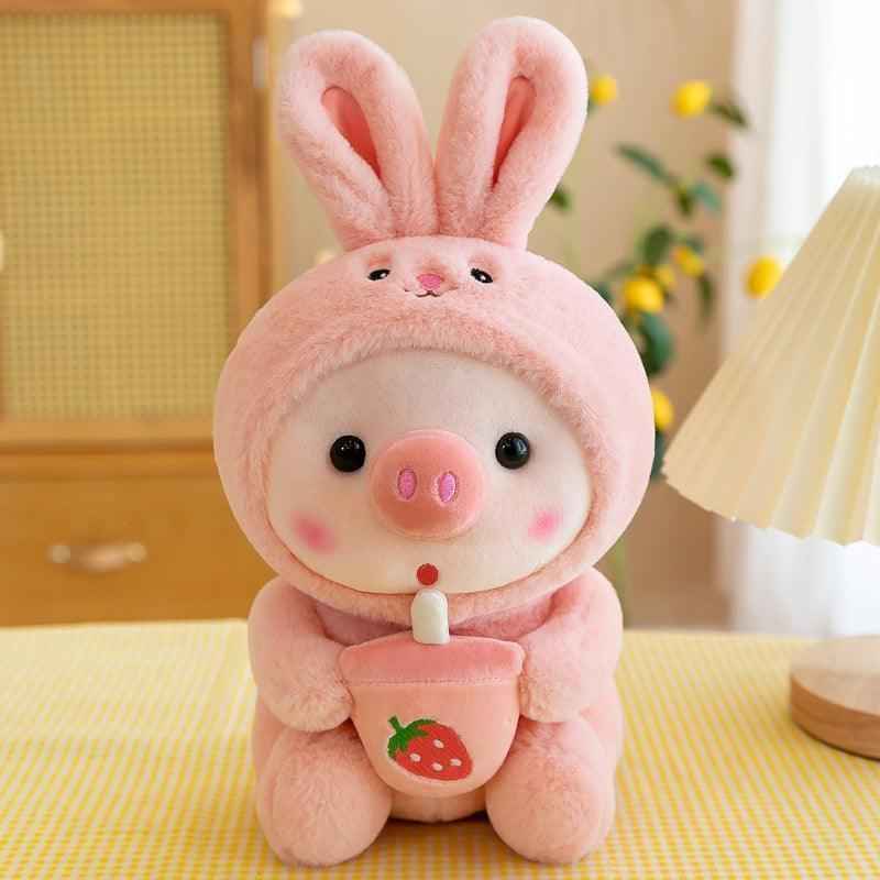 Pink plush rabbit stuffed animal standing, wearing strawberry bib with long ears