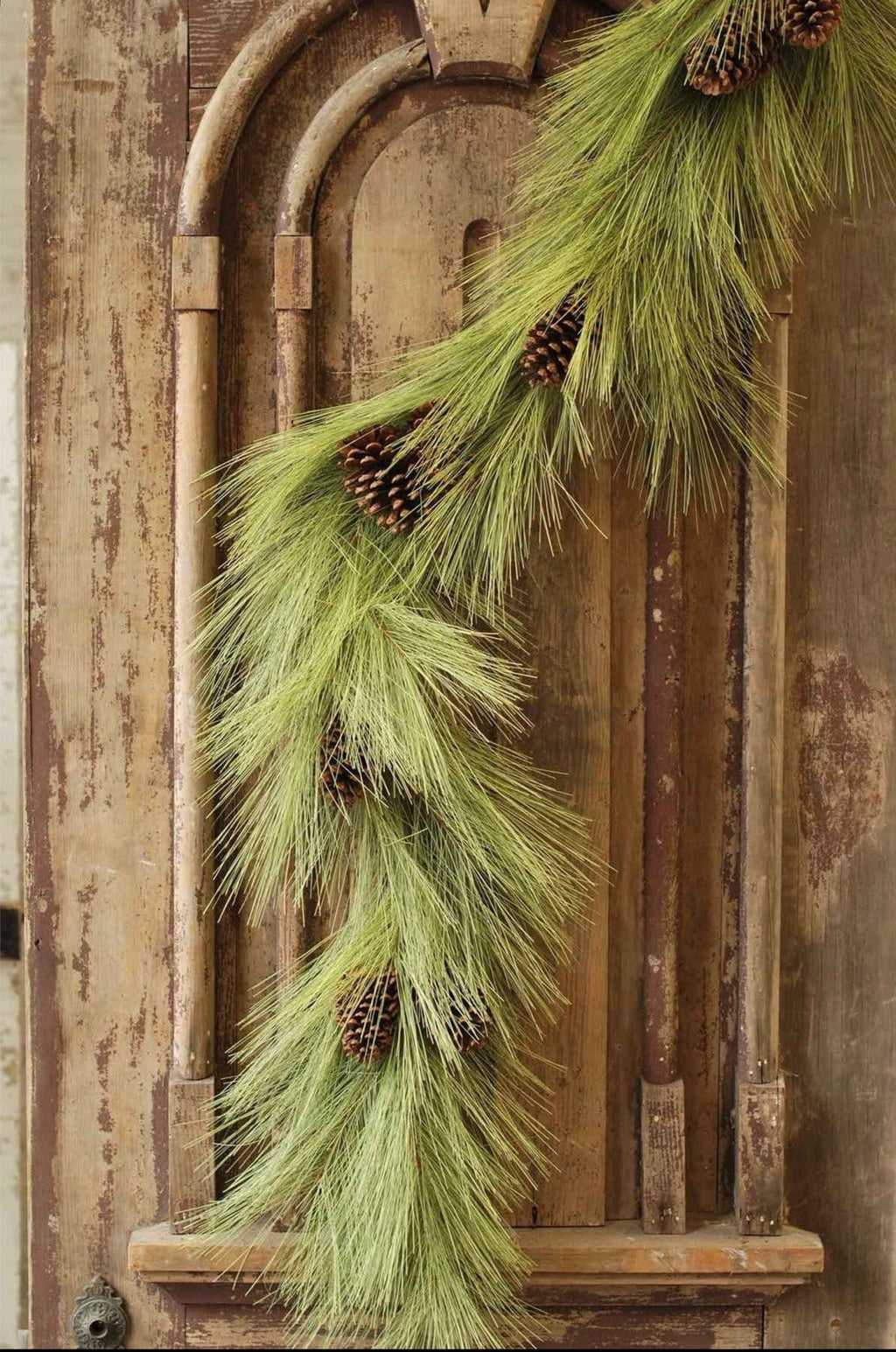 Faux pine garland with long green needles and small brown pinecones, 6 ft