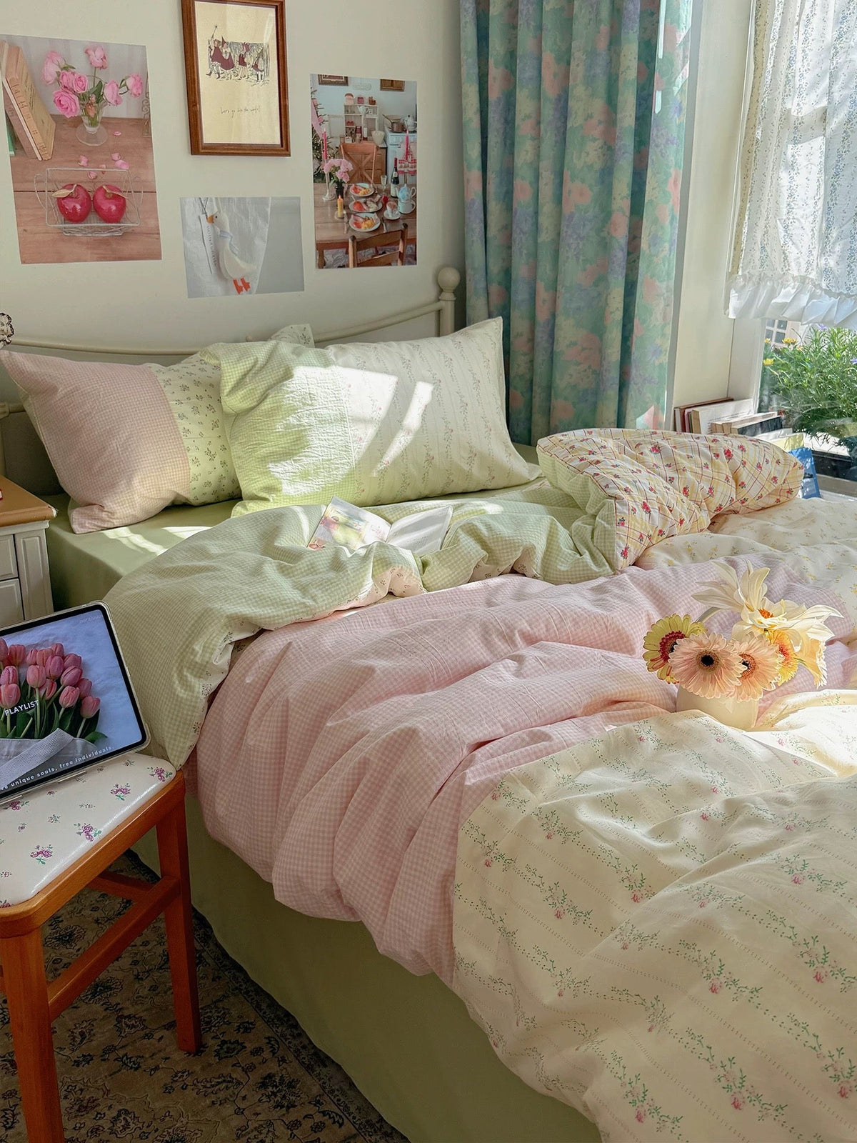 Pastel floral duvet cover set on bed with mint and pink layers and floral pillow shams
