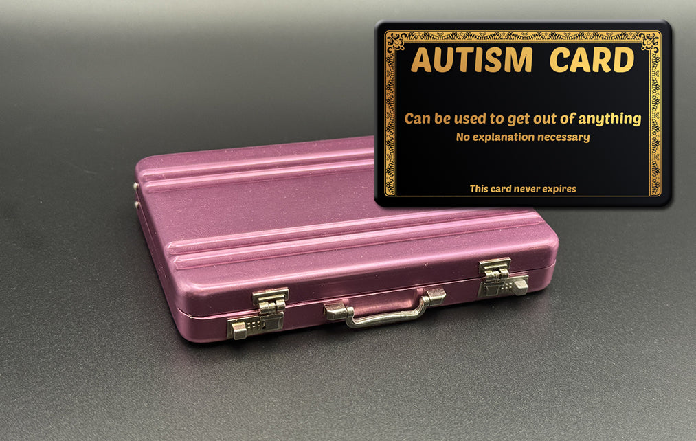 Pink mini briefcase with black “AUTISM CARD” card holder on top