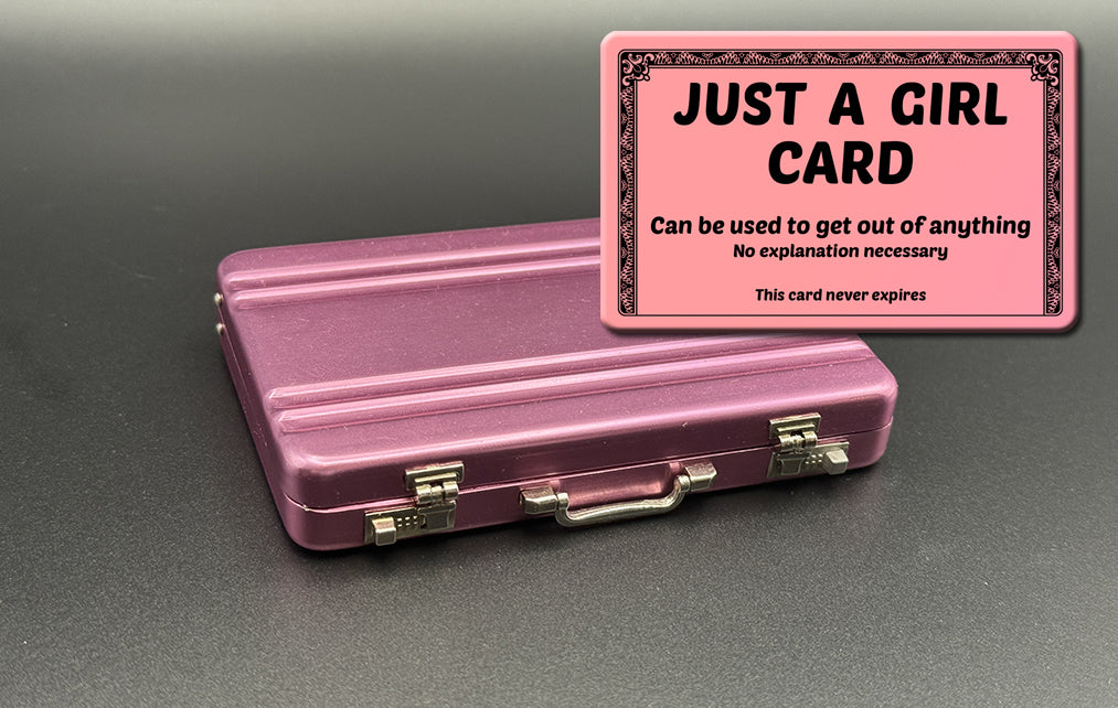 Pink mini briefcase with pink “JUST A GIRL” card holder on top