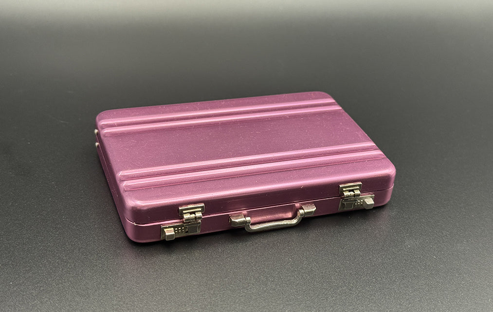 Pink mini briefcase with hinged top and metal clasp hardware