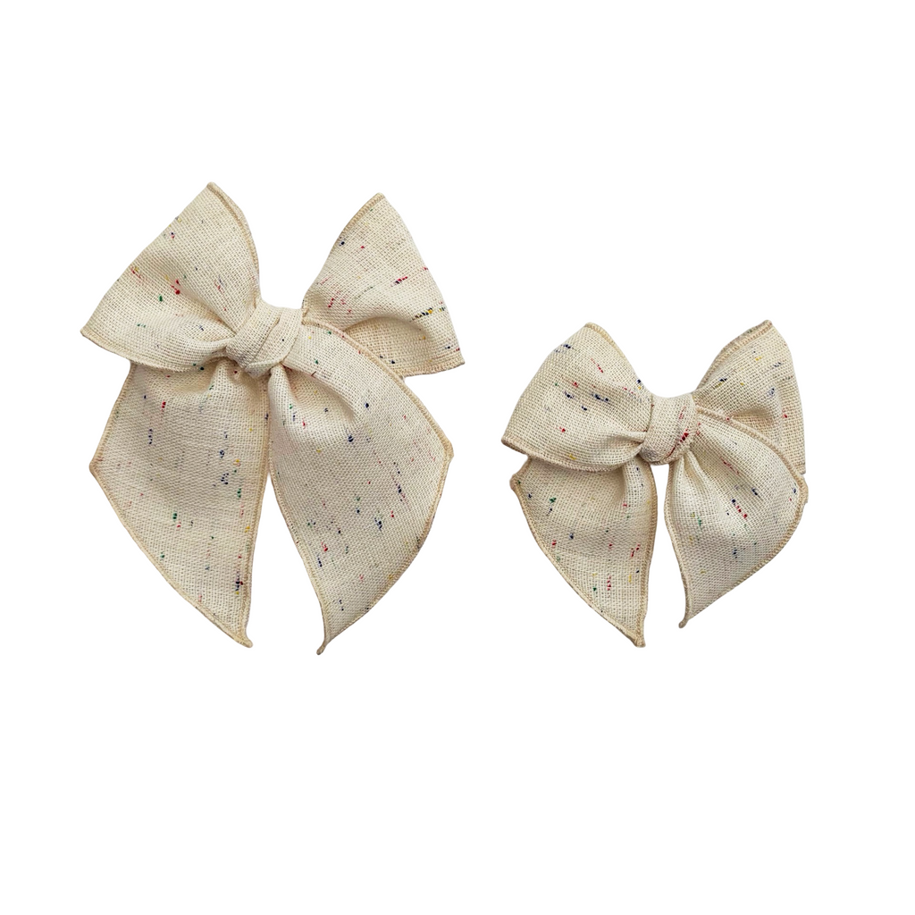Cream linen hair bow with multicolor confetti speckles and center knot