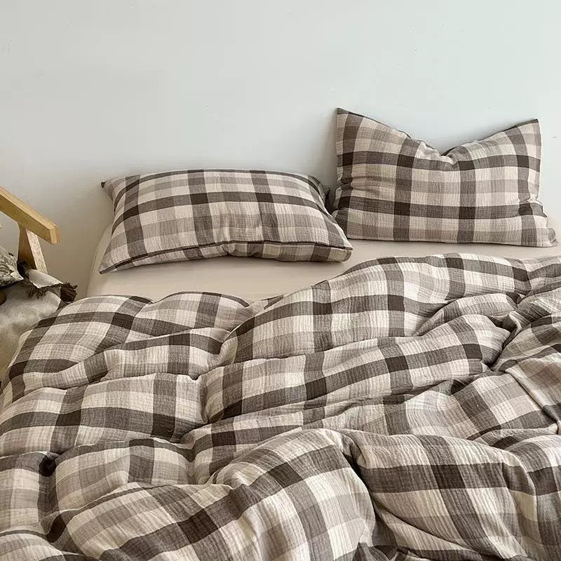 Brown-and-gray plaid duvet cover set with pillow shams, neatly arranged on the bed.