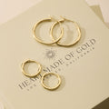 Gold hoop earring set with three pairs on display card