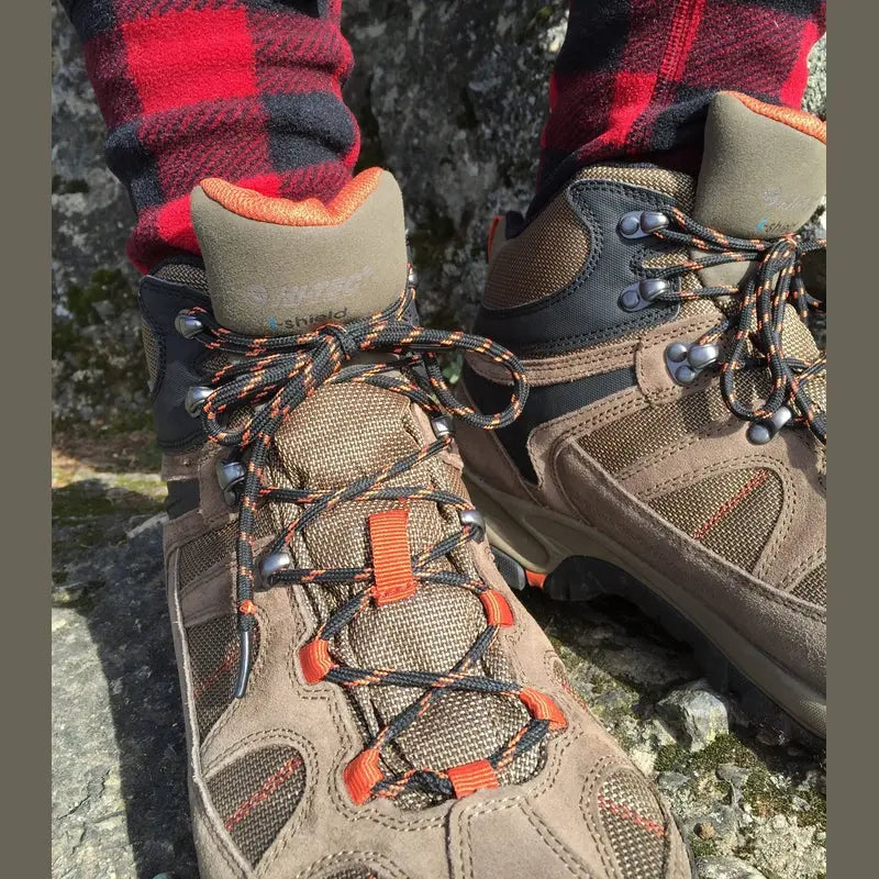 Red and black buffalo plaid crew socks worn with hiking boots, fleece texture visible.