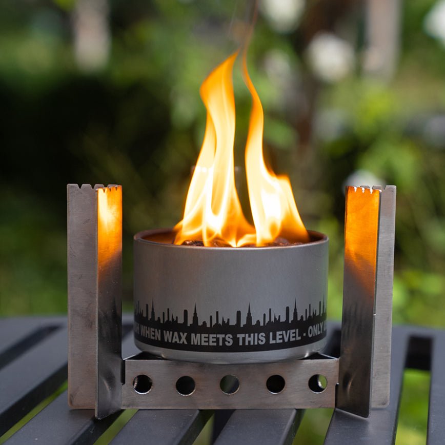 Portable camp stove burner with flames and upright side handles