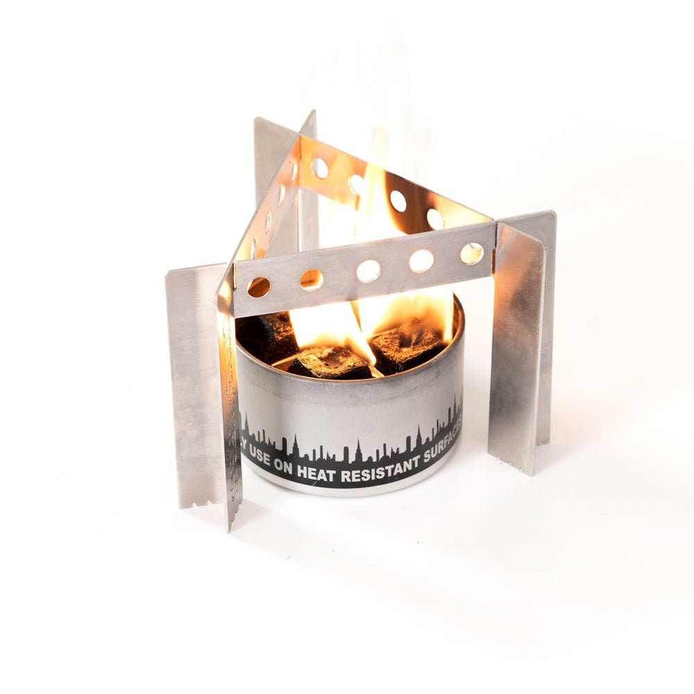 Portable camp stove burner with flames and heat-resistant metal wind shield