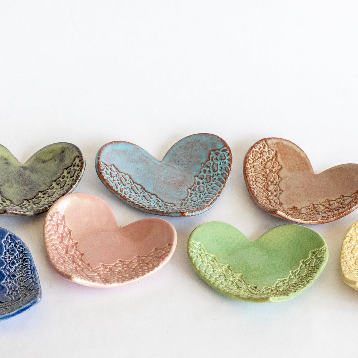 Assorted heart-shaped ring dish set in green, blue, pink, copper, and yellow glazes