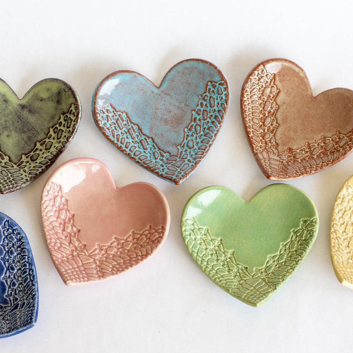 Set of heart-shaped ring dishes with textured interior, assorted green, blue, pink, and copper glazes
