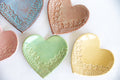Close-up of heart ring dishes in blue, copper, green, and yellow glossy textured glaze