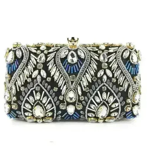 Black rhinestone minaudiere clutch with ornate gold and blue gem-style detailing