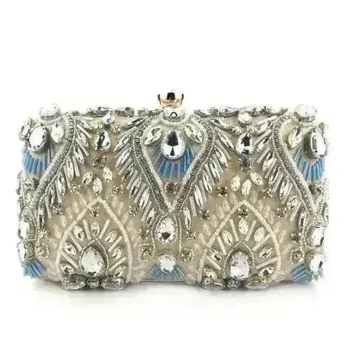 Champagne rhinestone minaudiere clutch with ornate silver-and-gold and blue accents