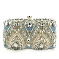 Champagne rhinestone minaudiere clutch with ornate silver-and-gold and blue accents