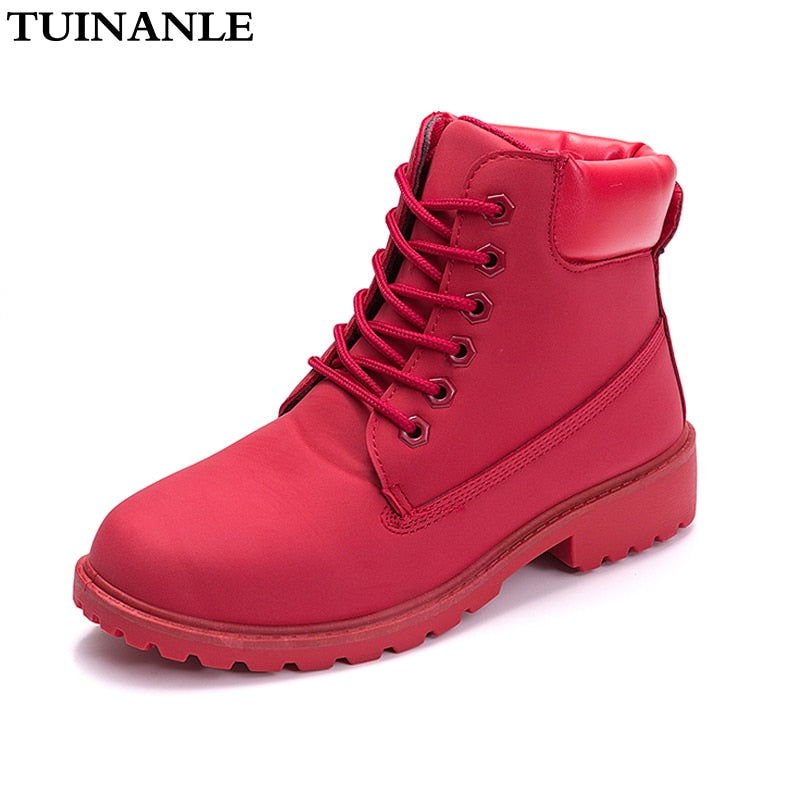 Red women’s plush ankle boots, lace-up front and chunky tread sole.