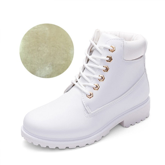 White women’s plush ankle boots, lace-up front with chunky tread outsole.