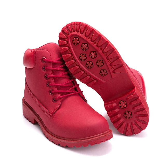Red plush ankle boots with treaded rubber outsole and lace-up front