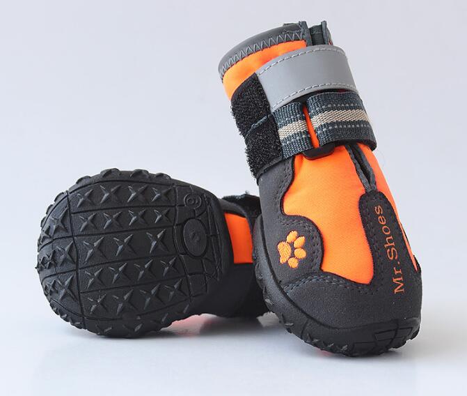 Orange and black waterproof dog boots with grippy tread sole and paw logo