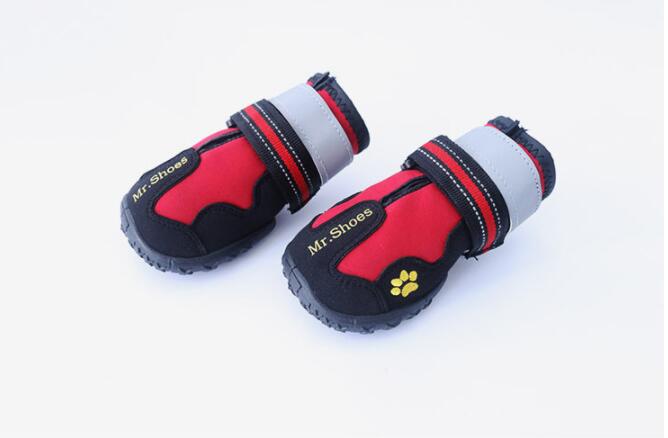 Pair of red waterproof dog shoes with paw-print accents and striped hook-and-loop bands
