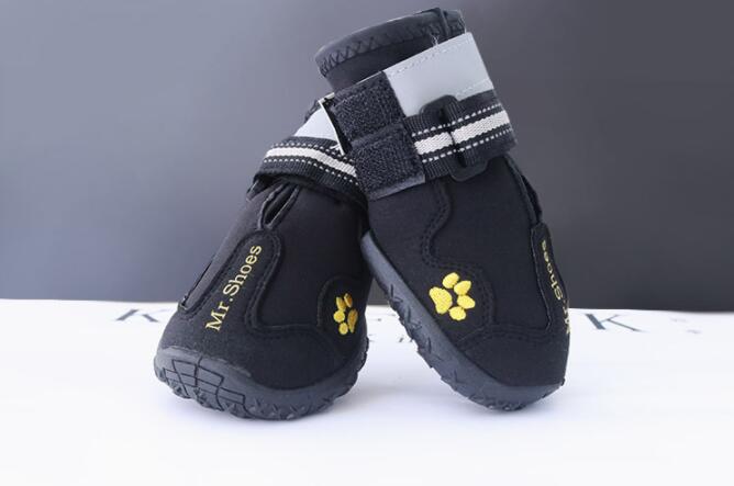 Black waterproof dog shoes with paw-print icons and adjustable hook-and-loop straps