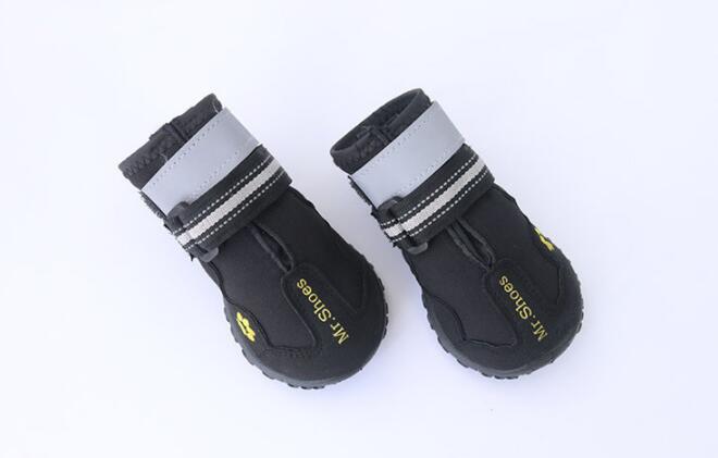 Black waterproof dog boots with hook-and-loop straps and paw-print accents