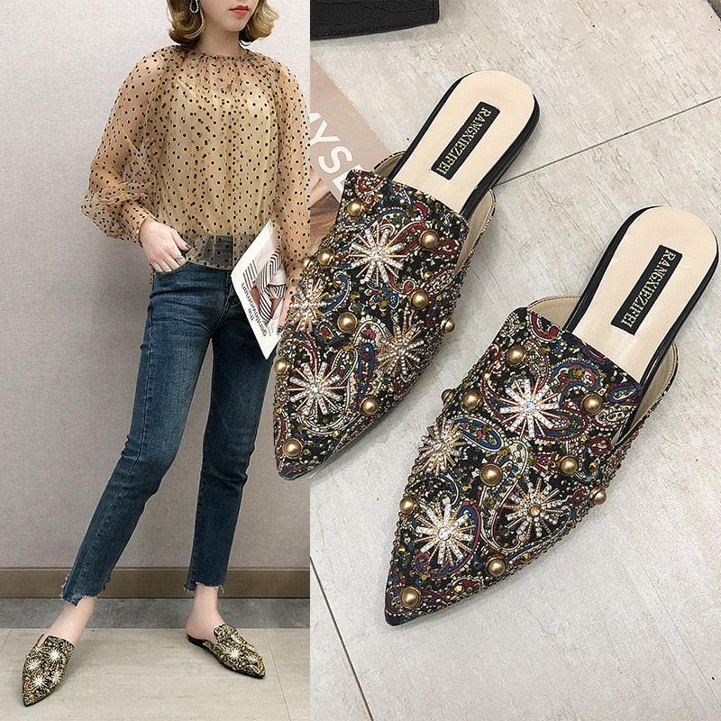 Embellished slip-on mules with multicolor stones, pearl-like studs, and low heel.