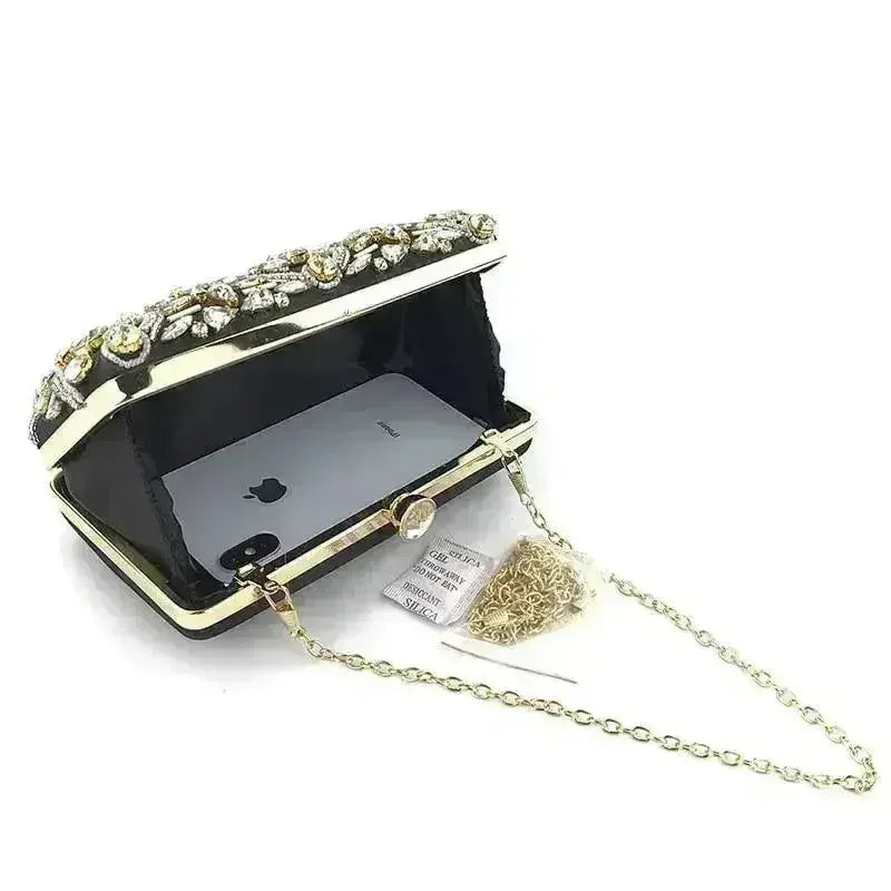 Open rhinestone clutch with gold-tone frame, black lining, and chain strap