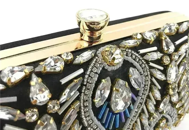Top clasp detail on diamond rhinestone clutch with crystal center and gold border