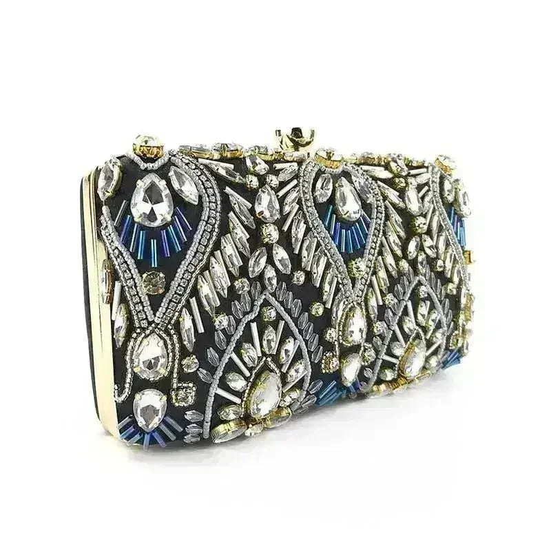 Black rhinestone minaudiere clutch with gold-tone frame and blue crystal accents