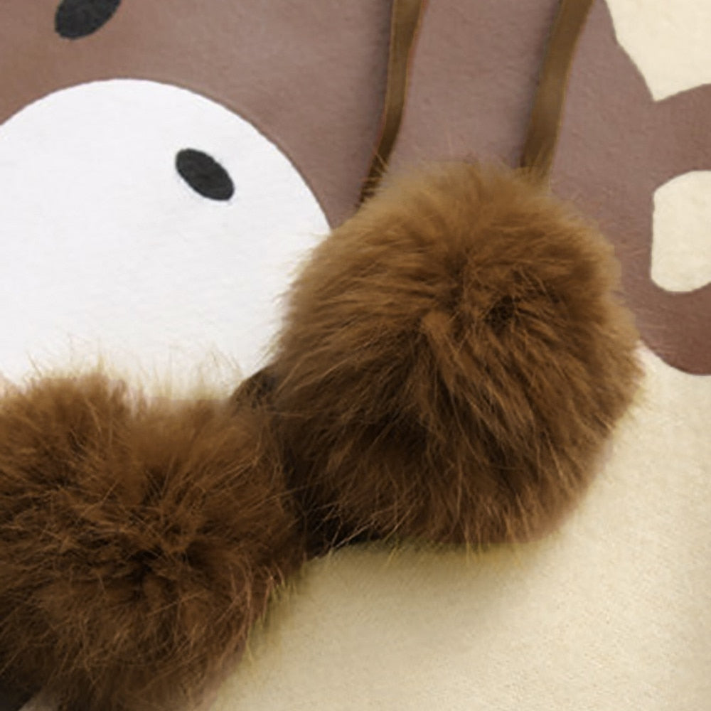 Brown plush bear hood detail on a light yellow hoodie