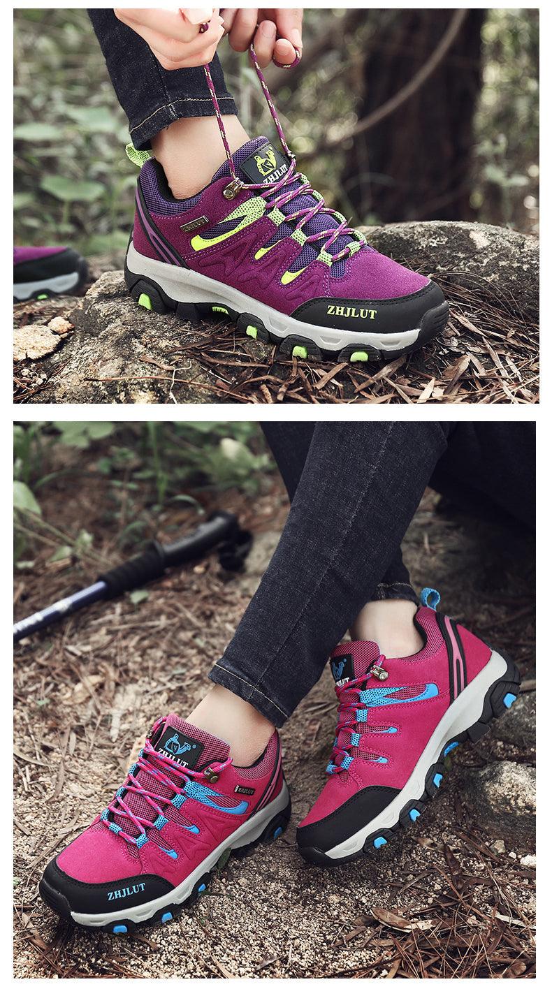 Purple low-top hiking shoes with green laces, worn outdoors on rough trail