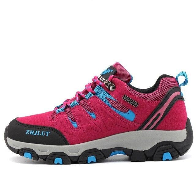 Low-top hiking shoes, bright magenta with teal-blue details and black rubber sole
