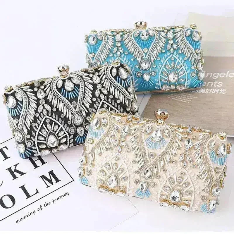 Blue rhinestone minaudiere clutch with ornate faceted design and gold-tone top clasp