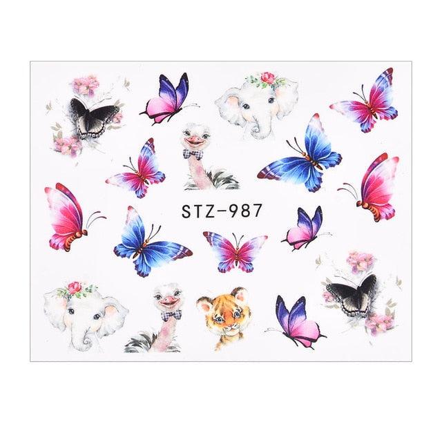 Butterfly nail water-transfer decal sheet with pastel butterflies, flowers, and small dog-like figures