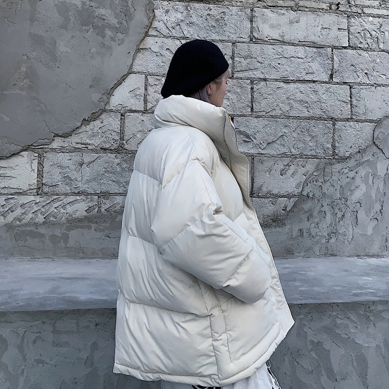 Off-white padded winter jacket, side view with full-zip and raised collar