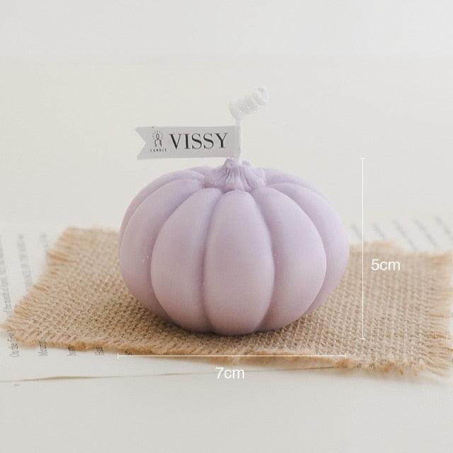 Lavender pumpkin-shaped candle on burlap square with VISSY tag