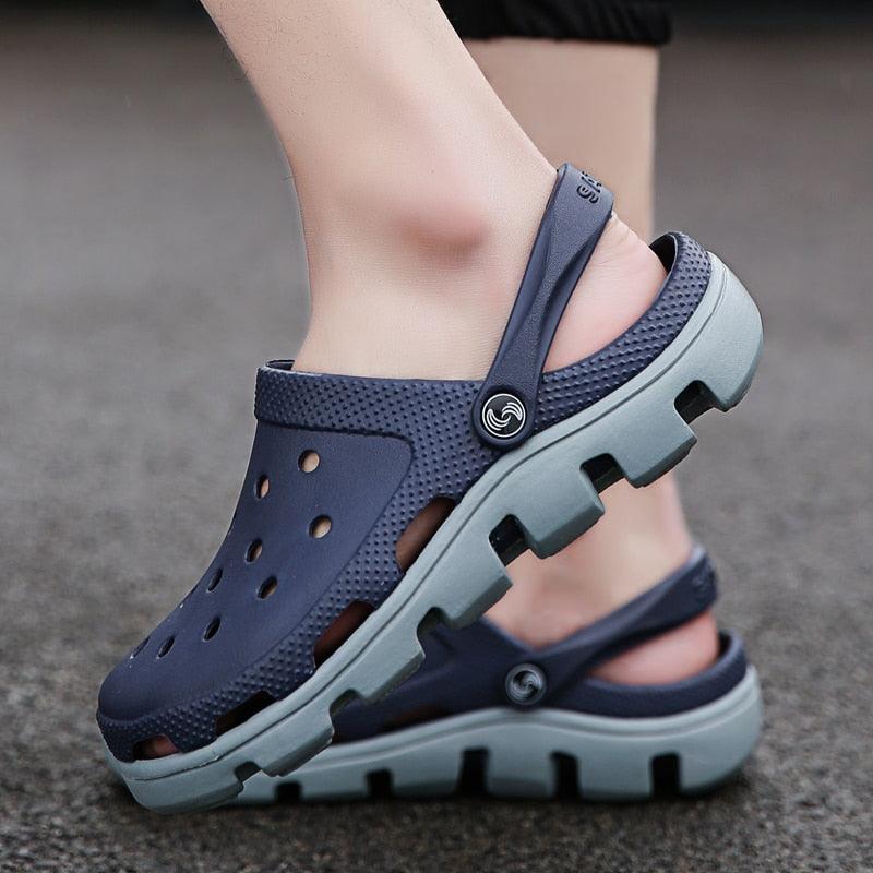 Men's navy perforated jelly clogs with adjustable strap and light gray tread