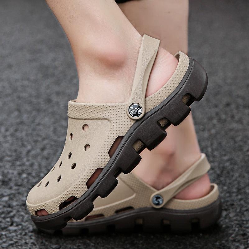 Beige men’s perforated clogs with adjustable heel strap and chunky black sole