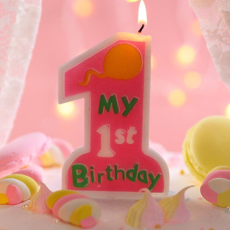 Pink "My 1st Birthday" number 1 candle topper with a bright flame
