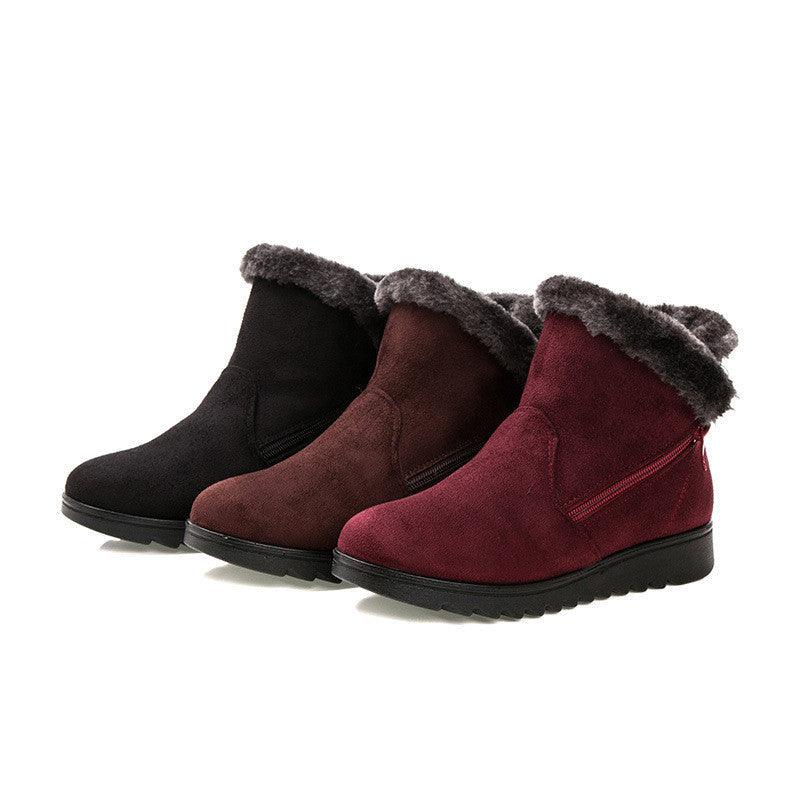 Women’s winter boots in black and burgundy with faux-fur cuffs and chunky tread soles.