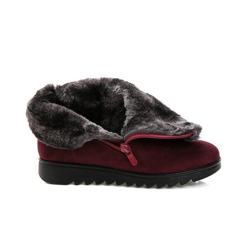 Women’s burgundy winter boots with faux-fur lining, front closure, and chunky tread sole.