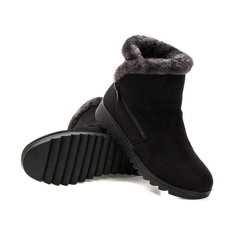 Women’s winter ankle boots in black suede with faux fur cuff, side zipper, and tread sole