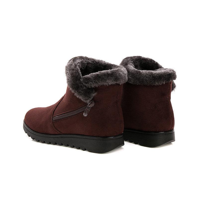 Women’s dark brown winter boots with faux-fur cuff and side zipper, chunky tread soles.